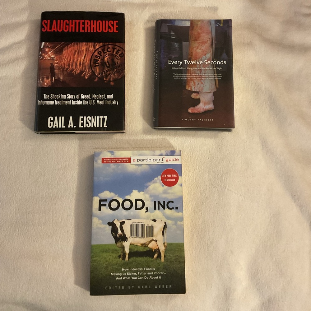 2 hardcover books about the meat industry and 1 paperback about the food